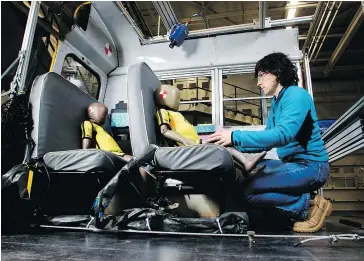  ?? TYREL FEATHERSTO­NE ?? Transport Canada’s Suzanne Tylko prepares crash test dummies for a simulated school bus crash near Montreal. School buses are made safer than regular buses