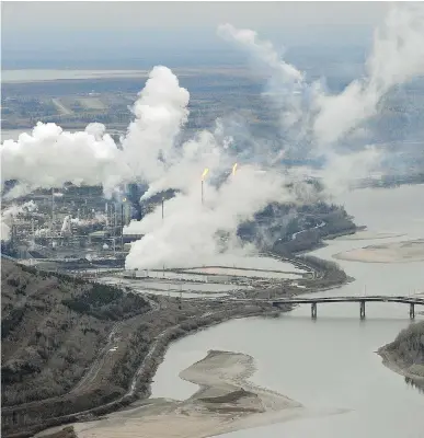  ?? MARK RALSTON/AFP/ GETTY IMAGES FILES ?? A Suncor oilsands plant on the banks of the Athabasca River in Alberta. With world oil production exceeding consumptio­n by nearly two million barrels a day, the current price of oil sits below $70 US.