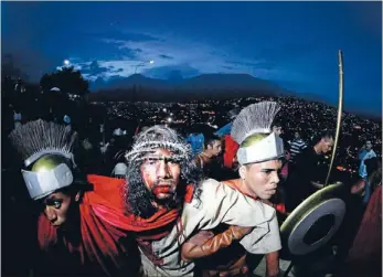  ?? Photo: REUTERS ?? On Good Friday: An actor dressed as Jesus Christ is taken to the cross in a re-enactment of Jesus’ crucifixio­n on Good Friday in Caracas’ biggest slum of Petare, in Venezuela.