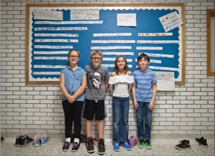  ?? MATHEW MCCARTHY, RECORD STAFF ?? St. Peter Catholic Elementary School students Addison Couckuyt, eight, left, Brayden Hudson, eight, Brooklyn Lang Golacki, nine and Nathan Panaccione, nine, have all learned the joy of math class now, thanks to extra efforts by the school, the board...