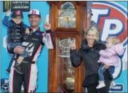  ?? MATT BELL — THE ASSOCIATED PRESS ?? Clint Bowyer, second from left, celebrates with his wife, Lorra, and children, Cash and Presley, after winning a NASCAR Cup Series auto race at Martinsvil­le Speedway in Martinsvil­le, Va. Monday.
