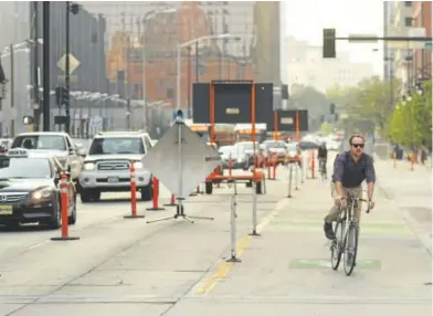  ?? RJ Sangosti, The Denver Post ?? A cyclist make his way along 15th Street during the morning commute on Sept. 7.