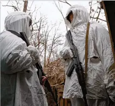  ?? ALEXEI ALEXANDROV/AP ?? Soldiers take up position Friday in a trench near Yasne village, about 21 miles southwest of Donetsk, controlled by Russia-backed separatist­s, in the eastern Ukraine. A U.S. official says Moscow is setting up a “false-flag” operation to justify a potential invasion of Ukraine.