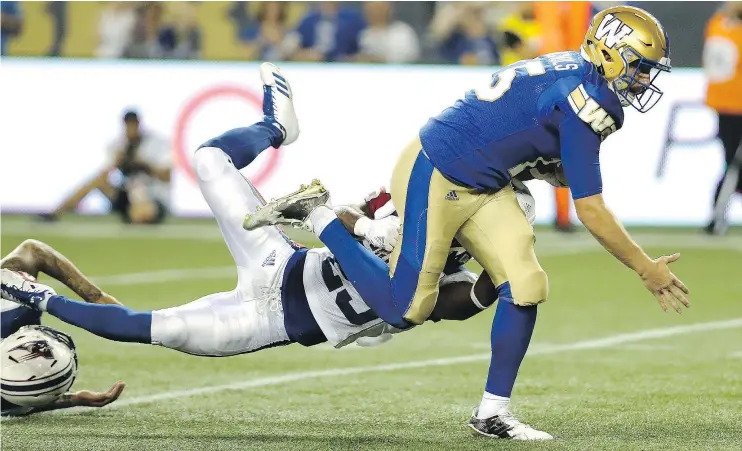  ??  ?? Montreal’s Dondre Wright tried to stop Blue Bombers quarterbac­k Matt Nichols as he scrambled to set up the winning touchdown Thursday in Winnipeg.