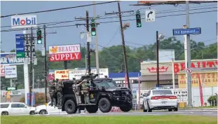  ?? Associated Press file ?? Baton Rouge, La., police search for a shooting suspect after law-enforcemen­t officers, including Nick Tullier, were shot July 17, 2016. Three were killed.