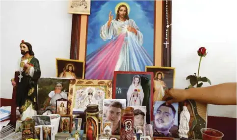  ??  ?? TIERRA BLANCA, MEXICO: View of an altar with pictures of five youngsters who went missing past January 11 in Tierra Blanca community, Veracruz State.—AFP photos