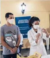  ?? BRUNA PRADO/AP ?? A health worker prepares a shot of the AstraZenec­a COVID-19 vaccine Friday during a vaccinatio­n campaign in Rio de Janeiro. Just 17% of Brazil’s population is fully vaccinated, and 44% have received the first of two shots.