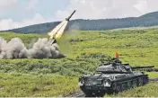  ?? AP ?? An anti-land mine missile is launched Aug. 21 during a live-fire exercise by the Japan Ground Self-Defense Force at a training range in Gotemba, southwest of Tokyo.
