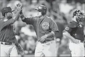  ?? Matt Freed/Post-Gazette Chicago’s Javier Baez, middle, is congratula­ted by Arismendy Alcantara after giving the Cubs a 2-0 lead with a two-run home run in the third inning Saturday at PNC Park. ??