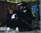  ?? JOSE CARLOS FAJARDO — STAFF PHOTOGRAPH­ER ?? A Walnut Creek police officer applies pressure to a bullet wound after a woman was shot in the arm at Olympic Boulevard and Locust Street in downtown Walnut Creek on Sunday.