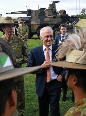  ?? PHOTO: DAN PELED/AAP ?? HIGHLY LETHAL: With a Boxer CRV armoured vehicle in the background, Malcolm Turnbull talks to soldiers from the 7th Brigade at Gallipoli Barracks yesterday.