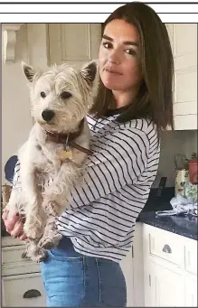  ??  ?? Puppy love: Hector the Westie enjoy cuddles with reader Rebecca Bell’s daughter Sophia