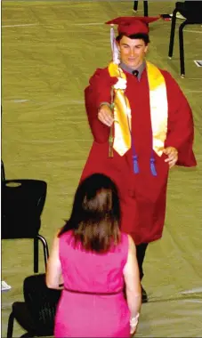  ?? MARK HUMPHREY ENTERPRISE-LEADER ?? Alec Pitts beams widely while presenting a flower to his mother, Guatha Pitts, during Lincoln’s graduation celebratio­n on Thursday. More photos are on Page 7A.