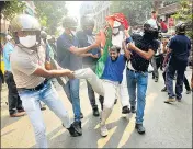  ?? ?? Police personnel detain a BJP supporter during a protest amid the civic polls, in Kolkata on Sunday.