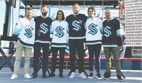  ?? ALIKA JENNER/GETTY IMAGES ?? Meet the Kraken. Jordan Eberle, left, Chris Driedger, Brandon Tanev, Jamie Oleksiak, Haydn Fleury and Mark Giordano pose in Seattle jerseys following the expansion draft on Wednesday in Seattle, Wash. The NHL'S newest team begins play in October.