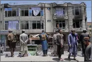  ?? (AP/Ebrahim Noroozi) ?? Taliban fighters stand guard at the site of an explosion in front of a Sikh temple Saturday in Kabul, Afghanista­n.