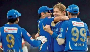  ??  ?? Rajasthan’s Shane Watson (second right) celebrates the wicket of Bangalore’s Chris Gayle with teammates.
— BCCI