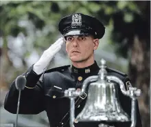  ?? DREW ANGERER GETTY IMAGES ?? A firefighte­r salutes at a ceremony for the victims of the September 11 terrorist attacks at the National September 11 Memorial in New York.