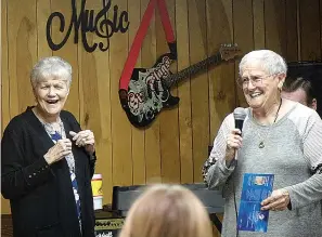  ?? ?? ■ Linda Warrick, right, has just told a crowd-pleasing joke about tapping one’s feet to music. “Leads to dancin’,” she said. Laughing with her is singer Janet Points.