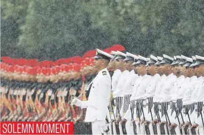  ?? Picture: Reuters ?? Indian soldiers stand in the rain during the swearing-in ceremony of India’s new president, Ram Nath Kovind, at the Rashtrapat­i Bhavan presidenti­al palace in New Delhi, India, yesterday.