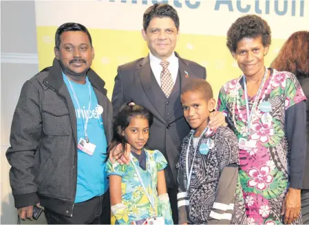  ?? Photo: Office of the Attorney-General ?? Front from left, 10-year-old Shalvi Shakshi, 12-year-old Timoci Naulusala; parents Surendra Raj and Raijieli Tinai pose with the head of Fijian delegation Aiyaz Sayed-Khaiyum (middle) at the COP23 meeting in Bonn, Germany.