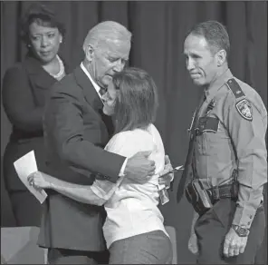  ?? AP/ BILL FEIG ?? Vice President Joe Biden hugs Dechia Gerald, widow of officer Matthew Gerald, during Thursday’s service in Baton Rouge. Attorney General Loretta Lynch ( left) and Baton Rouge Police Chief Carl Dabadie also were on hand.