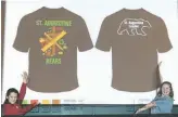  ??  ?? Elizabeth Sienna, left, and Mikayla Nevills, present their winning design for the school’s leadership t-shirt.
