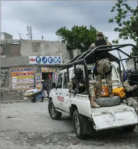  ?? MATIAS DELACROIX — THE ASSOCIATED PRESS ?? Security forces patrol the streets of Croix-des-bouquets, near Port-au-prince, Haiti, Tuesday, Oct. 19, 2021. A general strike continues in Haiti demanding that authoritie­s address the nation’s lack of security, four days after 17members of a U.s.-based missionary group were abducted by a gang.