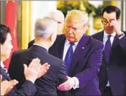  ?? Mandel Ngan AFP/Getty Images ?? PRESIDENT Trump and Chinese Vice Premier Liu He shake hands before signing the so-called Phase 1 agreement in the East Room at the White House.