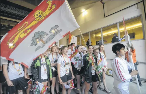  ?? JASON MALLOY/THE GUARDIAN ?? P.E.I. silver medallist Alexa McQuaid carries the flag into the closing ceremonies at the Canada Games in Winnipeg.
