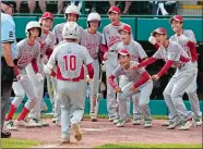  ??  ?? Japan’s Keitaro Miyahara (10) is greeted by teammates after hitting a solo home run during the fourth inning of a 12-2 win over Lufkin, Texas, in Sunday’s Little League World Series Championsh­ip game in South Williamspo­rt, Pa.