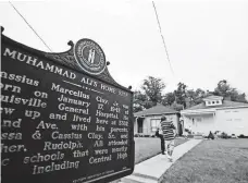  ?? DAVID GOLDMAN, AP ?? A historical marker in Louisville stands outside Muhammad Ali’s childhood home, where visitors have been paying respect.