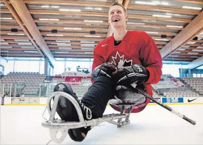  ?? JEFF MCINTOSH THE CANADIAN PRESS ?? Dominic Larocque, of Quebec City, a former soldier who lost his leg in Afghanista­n and who now plays for the Canadian national sledge hockey team, practises with teammates in Calgary on Tuesday, Dec. 4, 2012.