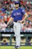  ?? MICHAEL WYKE — ASSOCIATED PRESS ?? Texas pitcher Cole Hamels reacts after hitting Houston’s George Springer with a pitch during the third inning Friday in Houston.
