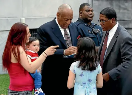  ??  ?? Bill Cosby signs a book for a family as he leaves the courthouse in Norristown, Pennsylvan­ia yesterday during a recess at his sexual assault trial.