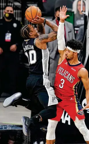  ?? Eric Gay / Associated Press ?? Despite not having played in two weeks, Demar Derozan has 32 points and 11 assists to carry the undermanne­d Spurs to a 117-114 victory over the Pelicans on Saturday night.
