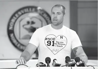  ?? Associated Press ?? ■ Jason Seaman, a seventh-grade science teacher at Noblesvill­e West Middle School in Noblesvill­e, Ind., speaks to the media during a press conference Monday, Seaman tackled and disarmed a student with a gun at the school on Friday. He was shot but not...