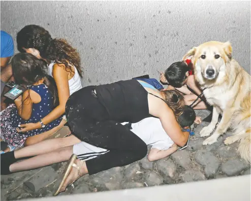  ?? GIL COHEN-MAGEN / AFP VIA GETTY IMAGES ?? Israelis take cover Wednesday under a bridge at the entrance of Tel Aviv after rockets were launched
toward Israel from the Gaza Strip controlled by the Hamas movement.