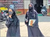  ?? PTI ?? Two students leave an examinatio­n centre in Udupi on Friday after allegedly not being allowed entry for wearing a hijab.