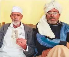  ?? Sana Jamal/Gulf News ?? Rasheed Ahmad, 98, Dulmial’s last living Second World War veteran, with his son (right).