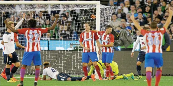  ?? GETTY IMAGES ?? The kids are all right: Tottenham’s young side appeal for offside after Diego Godin scores the only goal in a win for Atletico Madrid
