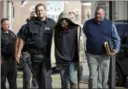  ?? SHOLTEN SINGER — THE HERALD-DISPATCH VIA AP ?? Lawrence County Sheriff Jeff Lawless escorts in Arron Lee Lawson after he was captured on Friday in Ironton, Ohio.