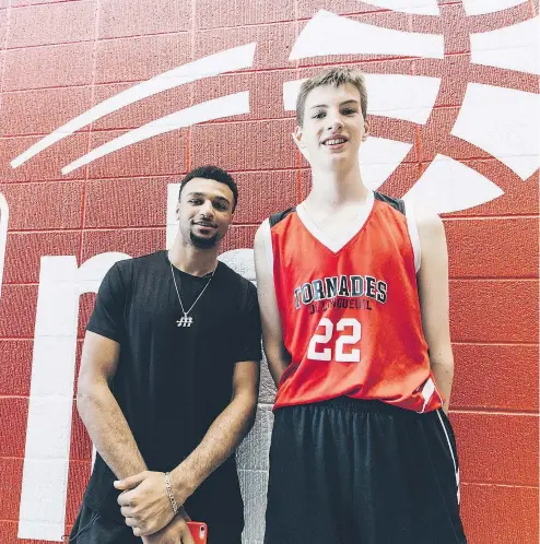  ?? CANADIAN PRESS ?? Denver Nuggets guard Jamal Murray, left, with 6-foot-10 centre Olivier Rioux. Needless to say, 12-year-old Rioux, has no trouble dunking the ball in his school games.