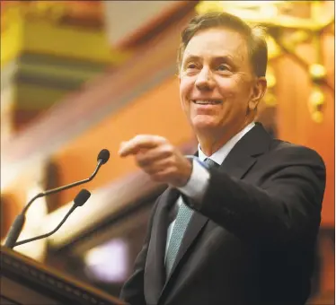  ?? Brian A. Pounds / Hearst Connecticu­t Media ?? Above, Gov. Ned Lamont delivers his budget address to the General Assembly at the Capitol in Hartford on Wednesday. At left, Department of Economic Community Developmen­t Commission­er David Lehman applauds during Lamont’s budget address.