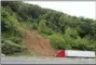  ?? CHUCK BURTON - THE AP ?? A truck passes an area on I-40 where traffic lanes were blocked in Old Fort, N.C., Wednesday, after heavy rains from the fringes of Subtropica­l Storm Alberto caused a mudslide Tuesday evening.