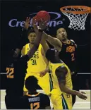  ?? JAMIE SQUIRE — GETTY IMAGES ?? Oklahoma State’s Cade Cunningham (2) and Kalib Boone (22) battle Baylor’s Mark Vital and MaCio Teague (31) for a rebound in their Big 12 Tournament semifinal game.