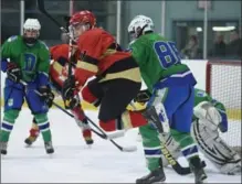  ?? PETER LEE, RECORD STAFF ?? Resurrecti­on’s Brandon Williams jumps to screen a shot on Celtics goalie Ethan Bulovas, as St. David’s Matthew Schouppe checks.