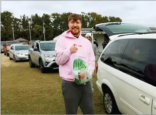  ?? BEAST PHILANTHRO­PY PRODUCTION­S VIA AP ?? Jimmy Donaldson, better known as MrBeast, during a turkey giveaway at Pitt County Fairground­s in Greenville, N.C. in Novem ber. The widely popular YouTube video maker has built an unusual charity playbook that leverages his fame and skills with the goal to end hunger.