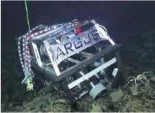  ?? OCEAN EXPLORATIO­N TRUST | GREGG DIFFENDALE VIA E/V NAUTILUS ?? ROV Argus, above left, is rigged with lifting straps for recovery from the sea floor. Above right: one of the remotely operated vehicles is lifted onto deck after being recovered from the sea floor.