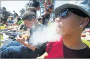 ?? STAFF FILE PHOTO ?? Sam Madarang smokes a marijuana cigarette at an all-day marijuana-focused event in Sharon Meadows, at Golden Gate Park, on April 20, 2017.
